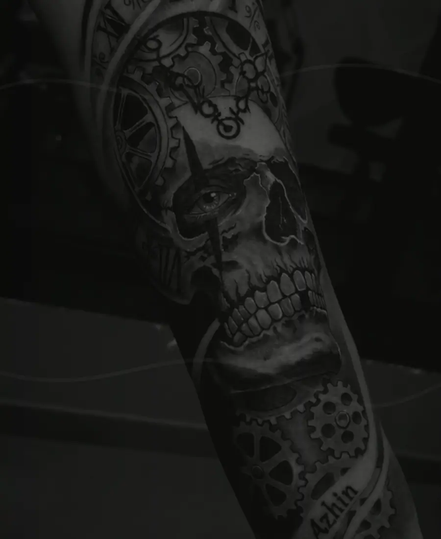 Faded black and grey tattoo before a cover-up transformation.